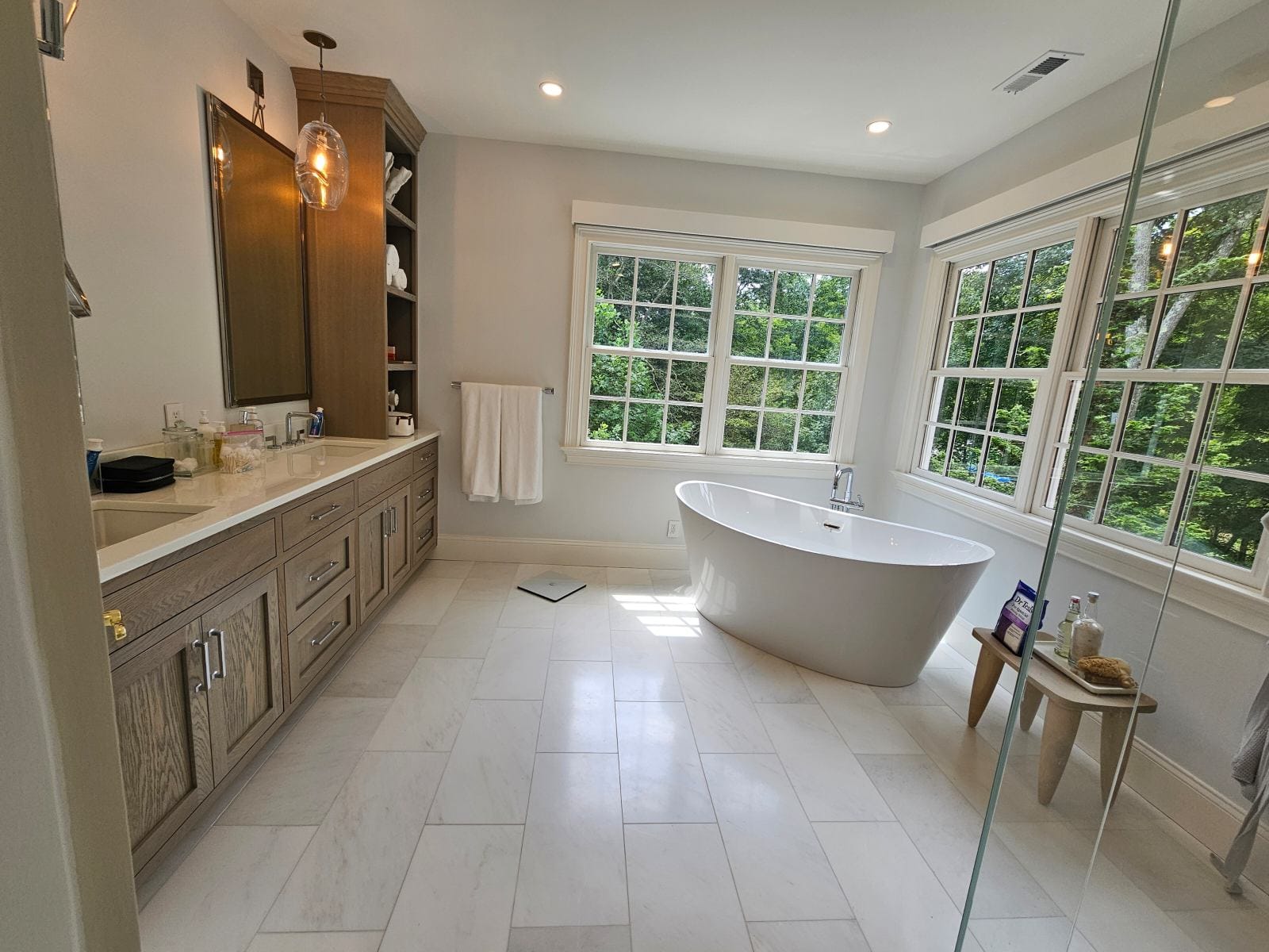 Spacious bathroom with freestanding tub and large windows