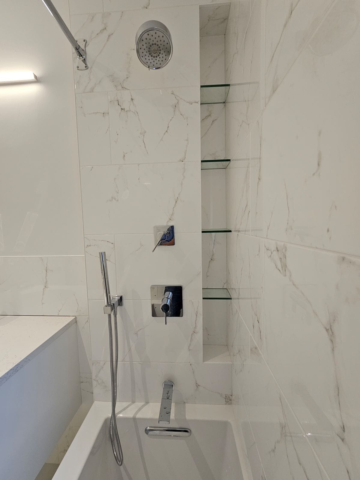 Sleek vanity and shower in a remodeled bathroom